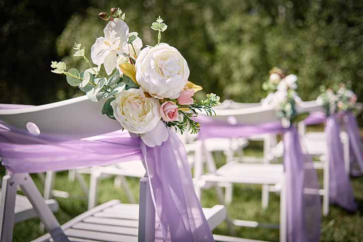 Plastic folding chairs - add elegance with flowers