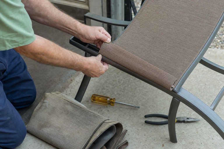 Hands fitting new sling fabric onto an aluminum patio chair frame