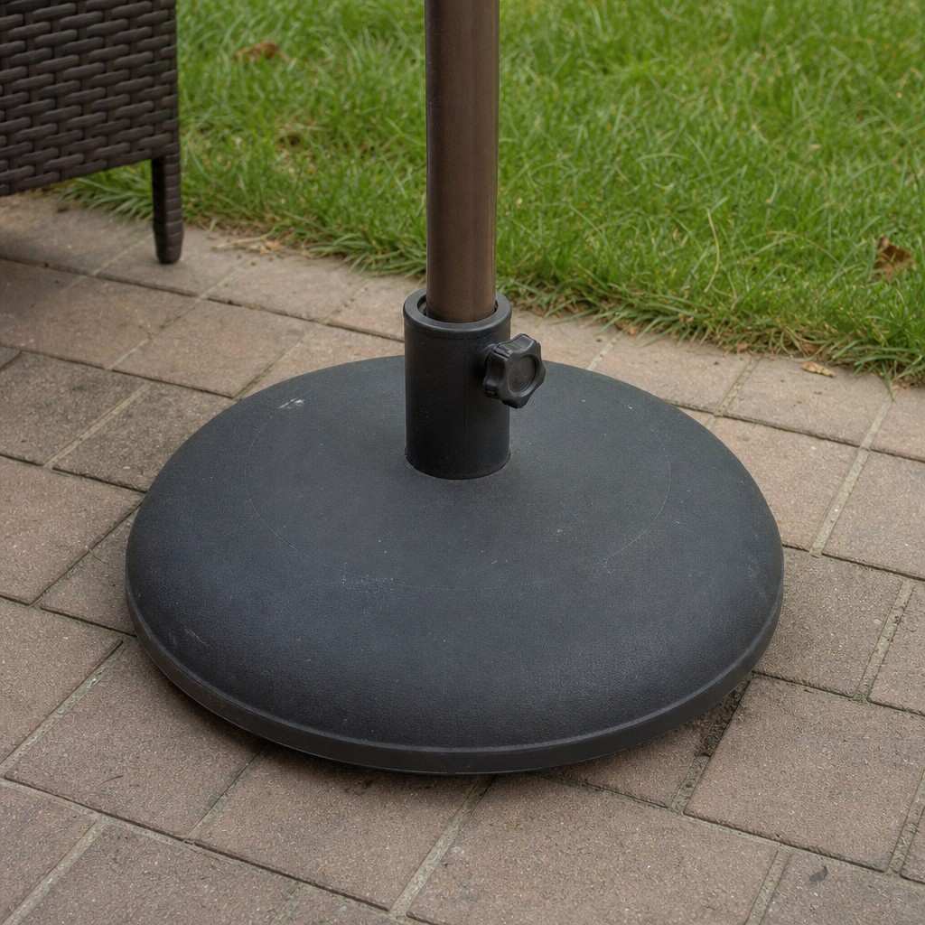 Close view of an umbrella pole seated in a weighted freestanding base